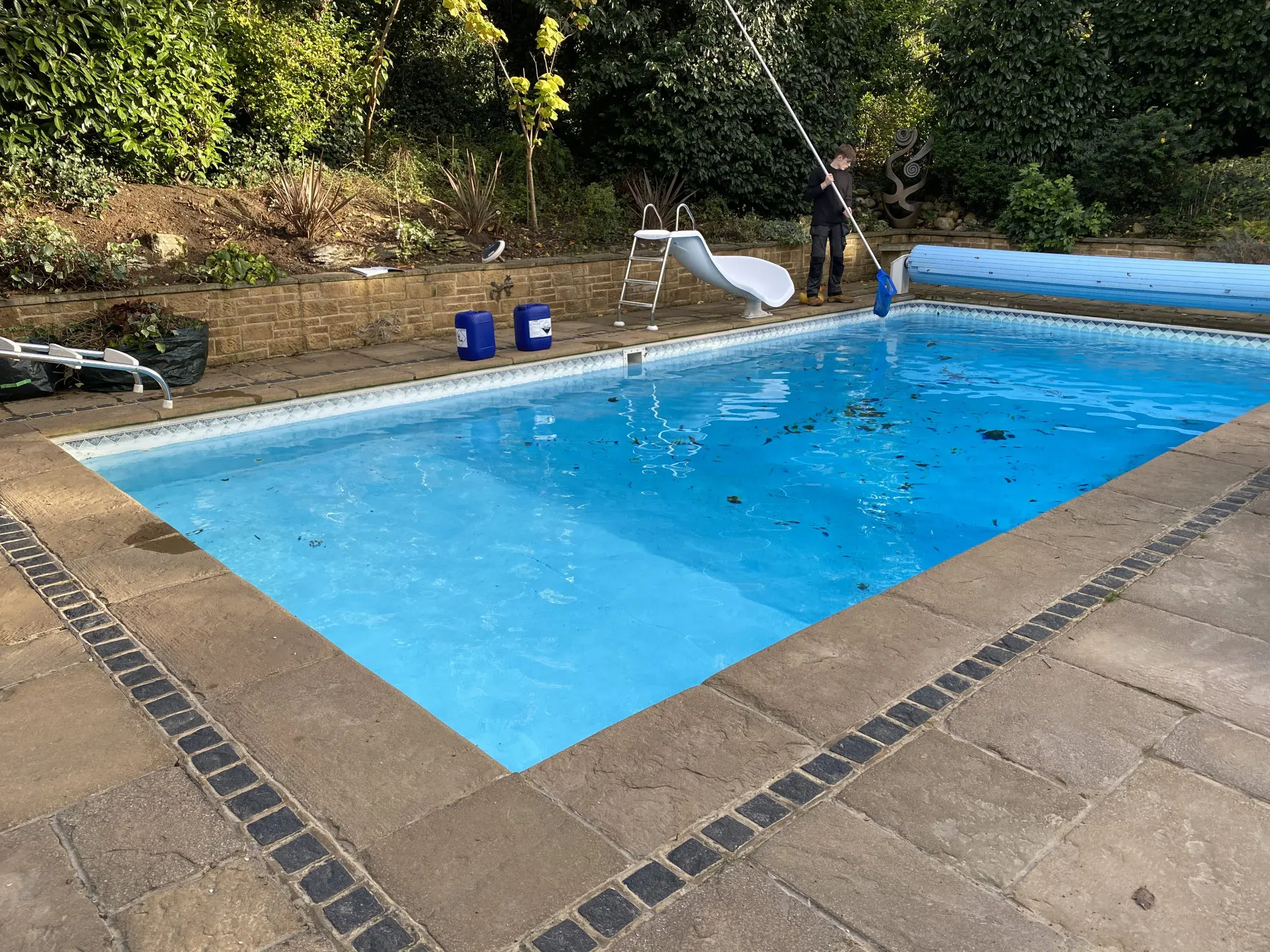 a man cleaning a pool